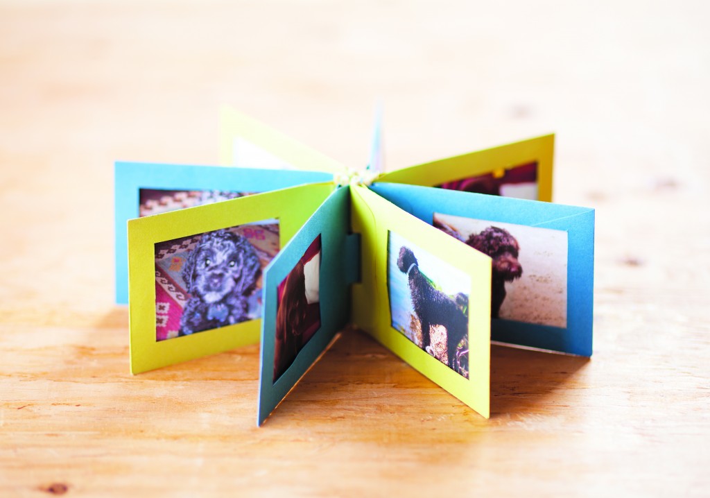 A mini photo album made from envelopes, featured in Playing With Paper