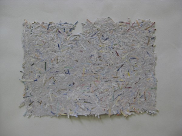 A sheet of handmade paper featuring international currencies 