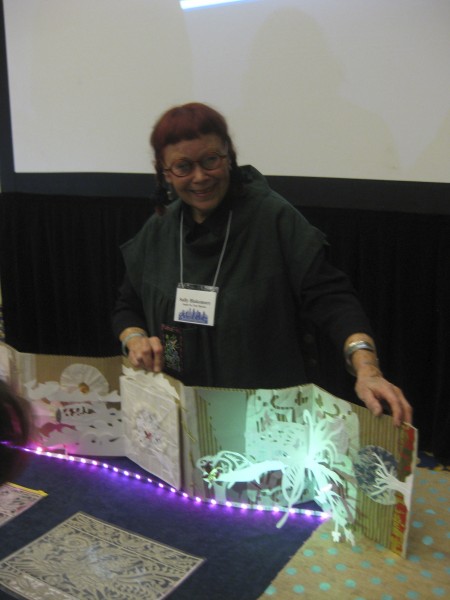 Sally Blakemore with her pop-up book that documents her experiences in China